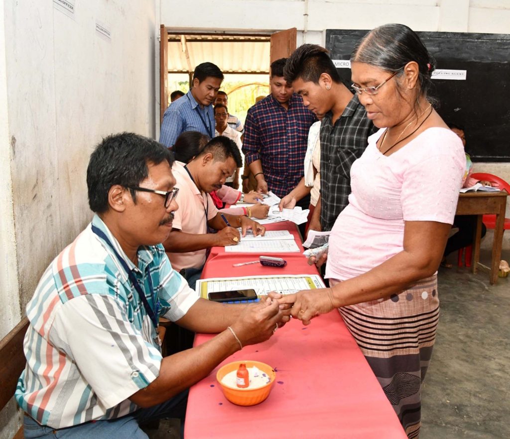 A polling official administering indelible ink to a voter, at a polling booth, during the 1st Phase of General Elections-2019, in Car Nicobar, Andaman and Nicobar Islands on April 11, 2019.