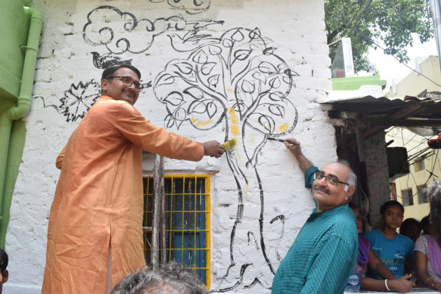 ABID members are painting the wall at the inaugural of The Makeover Story to mark the occassion of pre-independence day celebration