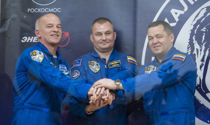 Expedition 47 prime crew members: Flight Engineer Jeff Williams of NASA, left; Soyuz Commander Alexey Ovchinin of Roscosmos, center; and Flight Engineer Oleg Skripochka of Roscosmos, right; pose for a photo at the conclusion of a press conference on Thursday, March 17, 2016, at the Cosmonaut Hotel in Baikonur, Kazakhstan. Launch of the Soyuz rocket is scheduled for March 19 Baikonur time and will carry Skripochka, Ovchinin, and Williams into orbit to begin their five and a half month mission on the International Space Station.