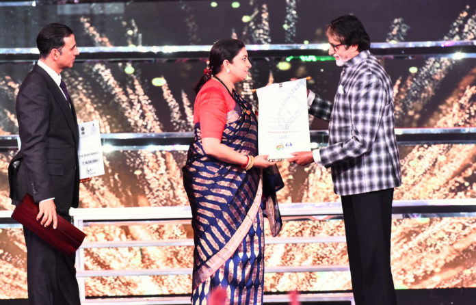 The Union Minister for Textiles and Information & Broadcasting, Smt. Smriti Irani presenting the Indian Film Personality of the Year Award to Bollywood legend Amitabh Bachchan, at the closing ceremony of the 48th International Film Festival of India (IFFI-2017), in Panaji, Goa on November 28, 2017.
