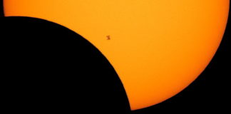 The International Space Station is seen in silhouette from Northern Cascades National Park in Washington as it transits the Sun at roughly five miles per second during a solar eclipse on Aug. 21, 2017. Photo Credit: NASA/Bill Ingalls (PRNewsfoto/NASA)