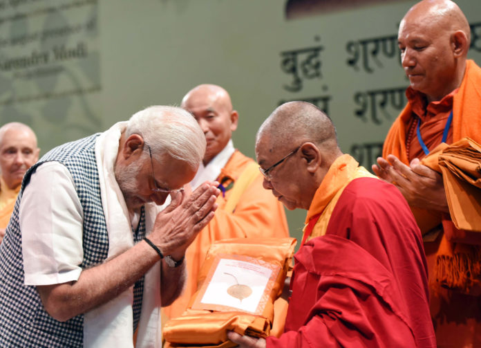 The Prime Minister, Shri Narendra Modi offering Sangh Dana, at the inauguration of Buddha Jayanti Celebrations in New Delhi on April 30, 2018.