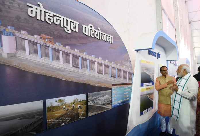 The Prime Minister, Shri Narendra Modi visiting an exhibition before dedicating the Mohanpura Project to the Nation, in Madhya Pradesh on June 23, 2018. The the Chief Minister of Madhya Pradesh, Shri Shivraj Singh Chouhan is also seen.