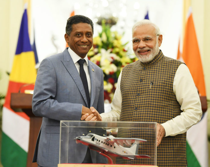 The Prime Minister, Shri Narendra Modi handing over replica of Dornier Aircraft to the President of the Republic of Seychelles, Mr. Danny Antoine Rollen Faure, at Hyderabad House, in New Delhi on June 25, 2018.