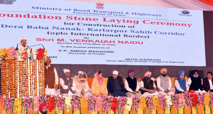 The Vice President, Shri M. Venkaiah Naidu addressing the gathering after laying foundation stone for Kartarpur Corridor, in Gurdaspur, Punjab on November 26, 2018. The Governor of Punjab & the Administrator of Chandigarh, Shri V.P. Singh Badnore, the Union Minister for Road Transport & Highways, Shipping and Water Resources, River Development & Ganga Rejuvenation, Shri Nitin Gadkari, the Union Minister for Food Processing Industries, Smt. Harsimrat Kaur Badal, the Chief Minister of Punjab, Captain Amarinder Singh, the Minister of State for Housing and Urban Affairs (I/C), Shri Hardeep Singh Puri, the Minister of State for Social Justice & Empowerment, Shri Vijay Sampla and other dignitaries are also seen.