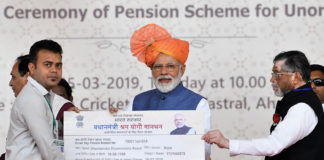 The Prime Minister, Shri Narendra Modi distributing the PM-SYM Pension Cards to select beneficiaries, at a function, in Vastral, Gujarat on March 05, 2019. The Minister of State for Labour and Employment (I/C), Shri Santosh Kumar Gangwar is also seen.