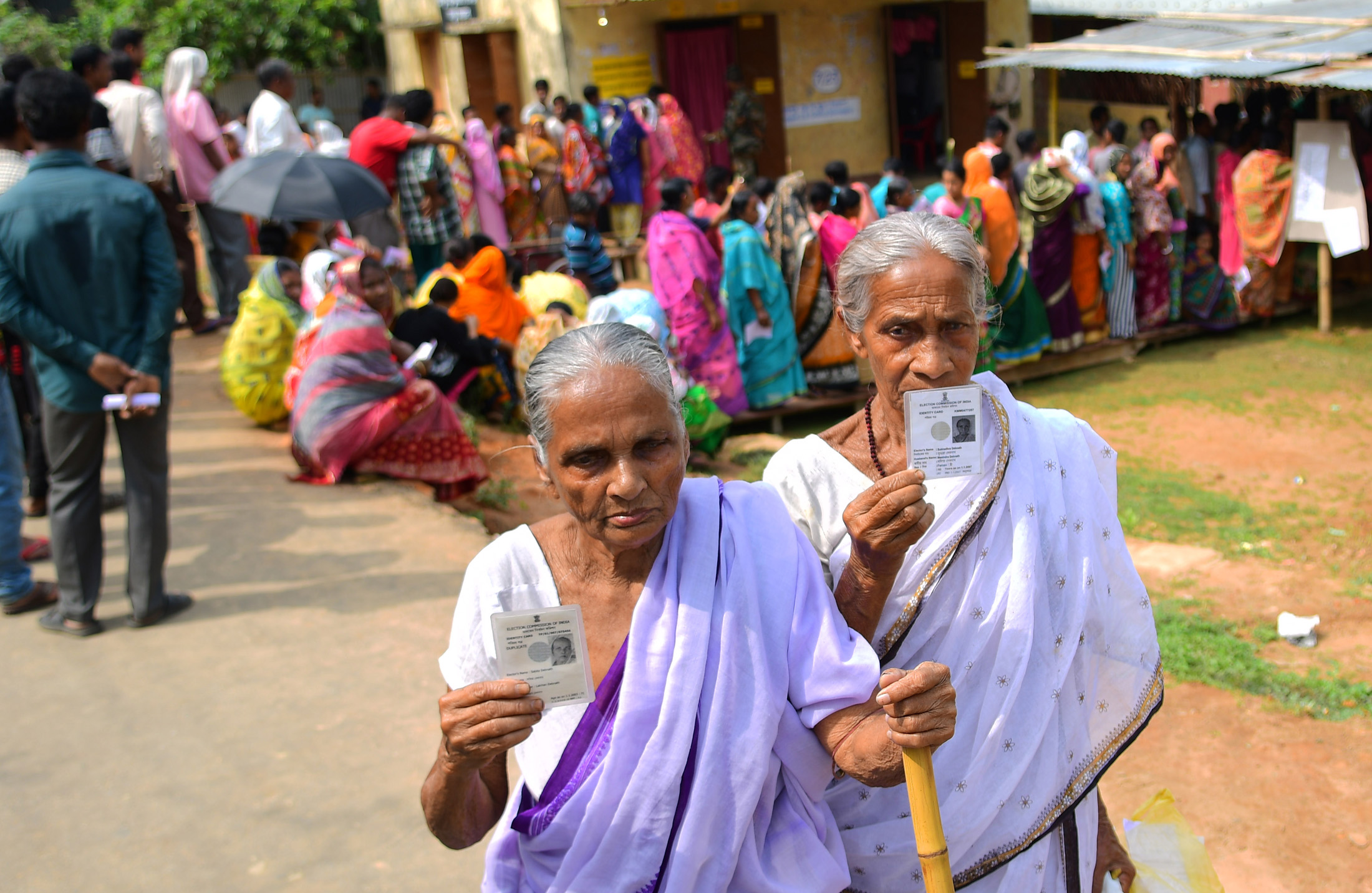 The elderly female voters displaying identity cards, at a polling booth, during the 1st Phase of General Elections-2019, at West Tripura on April 11, 2019.