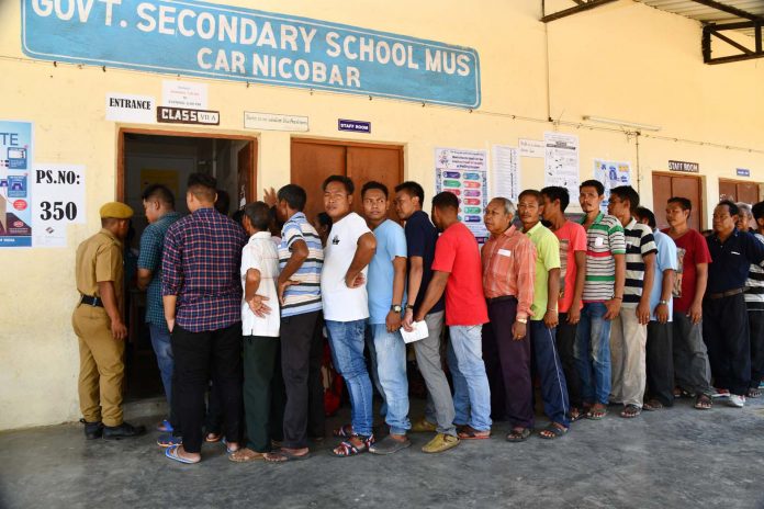 The voters standing in the queues to cast their votes, at a polling booth, during the 1st Phase of General Elections-2019, in Car Nicobar, Andaman and Nicobar Islands on April 11, 2019.