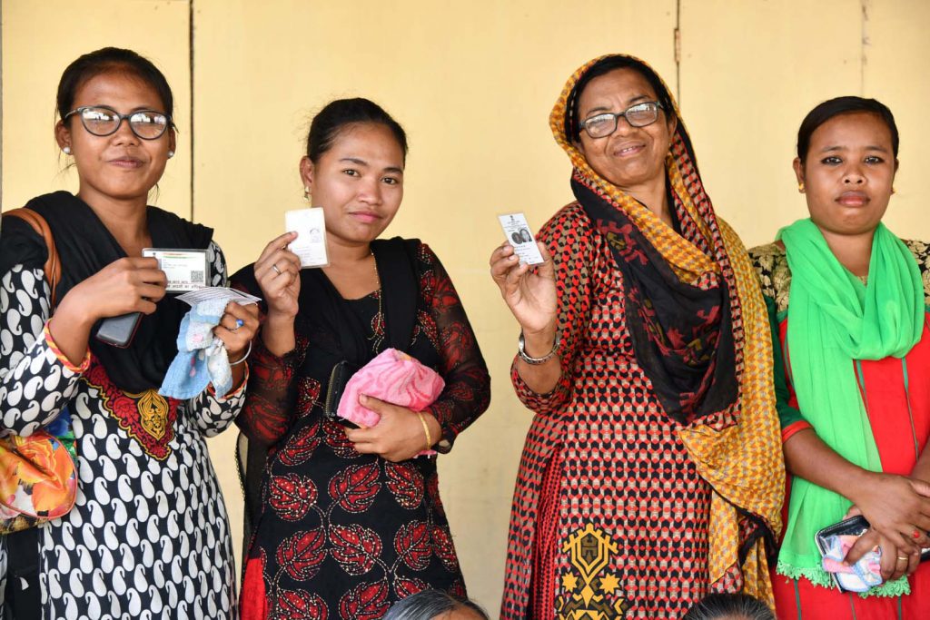 The voters displaying identity cards at a polling booth, during the 1st Phase of General Elections-2019, in Car Nicobar, Andaman and Nicobar Islands on April 11, 2019.