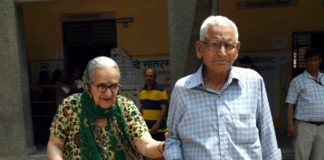 An old couple voters arrive at a polling booth, during the 6th Phase of General Elections-2019, at Rohini, in New Delhi on May 12, 2019.