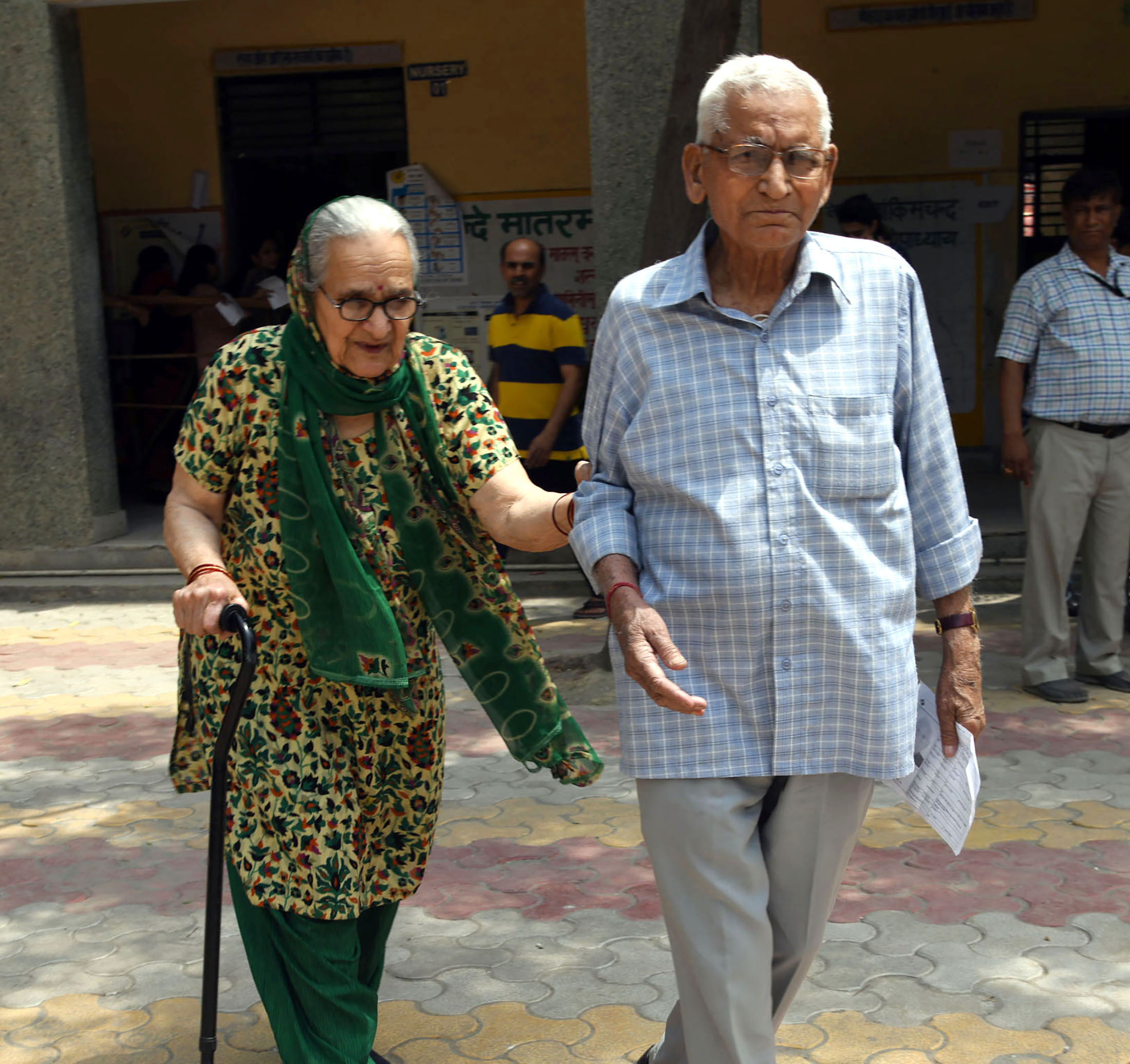 An old couple voters arrive at a polling booth, during the 6th Phase of General Elections-2019, at Rohini, in New Delhi on May 12, 2019.