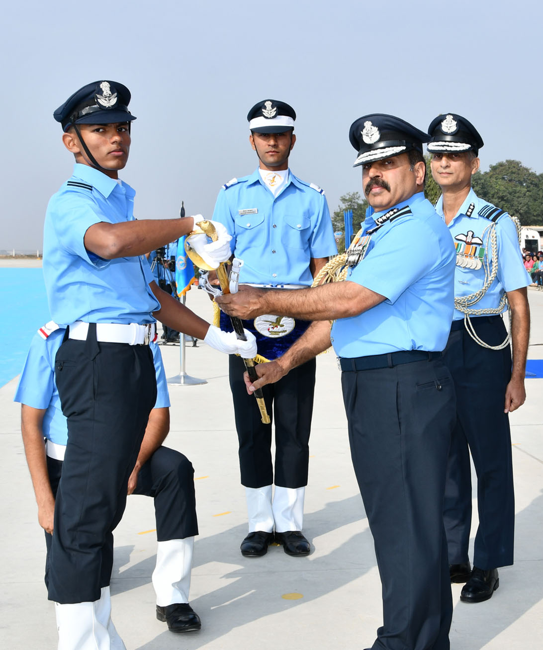 The Chief of the Air Staff, Air Chief Marshal R.K.S. Bhadauria Staff presenting the sword of honour to Flying Officer Arunabha Chakraborty form the flying branch for standing first in overall merit in the Pilots course, during the Combined Graduation Parade at Air Force Academy, Dundigal, in Hyderabad on December 21, 2019.