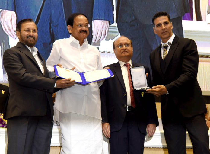 The Vice President, Shri M. Venkaiah Naidu presenting the Rajat Kamal Award to Shri Akshay Kumar for Best Film on Social Issues: Padman, at the 66th National Film Awards function, in New Delhi on December 23, 2019. The Union Minister for Environment, Forest & Climate Change, Information & Broadcasting and Heavy Industries and Public Enterprise, Shri Prakash Javadekar and the Secretary, Ministry of Information & Broadcasting, Shri Ravi Mittal are also seen.