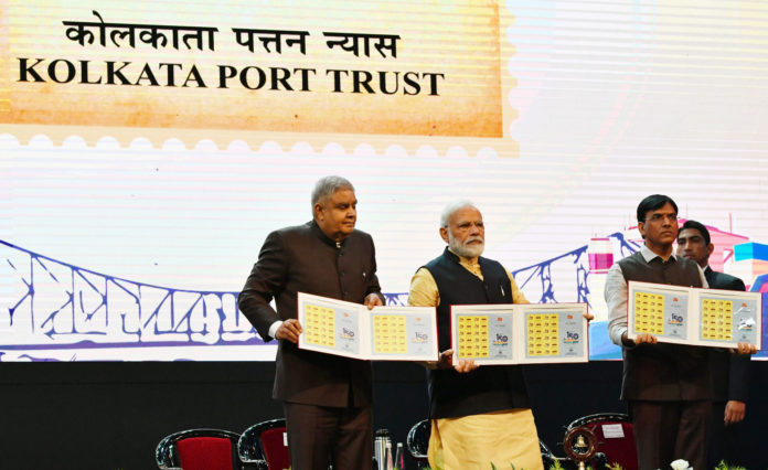 The Prime Minister, Shri Narendra Modi releasing the commemorative stamp marking celebrations of 150 years of Kolkata Port Trust, in Kolkata, West Bengal on January 12, 2020. The Governor of West Bengal, Shri Jagdeep Dhankhar and the Minister of State for Shipping (Independent Charge) and Chemicals & Fertilizers, Shri Mansukh L. Mandaviya are also seen.