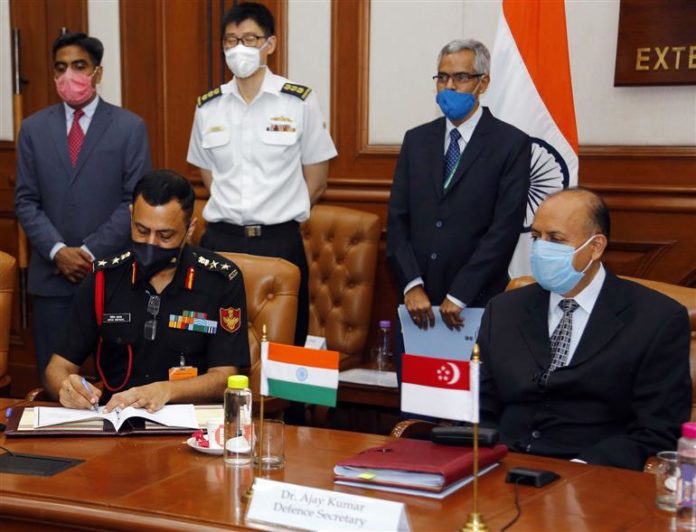 The Defence Secretary, Dr. Ajay Kumar witnessing the signing of Implementing Arrangement on Humanitarian Assistance & Disaster Relief (HADR) between India and Singapore, during the 14th India-Singapore Defence Policy Dialogue (DPD) via video conferencing, in New Delhi on August 28, 2020.