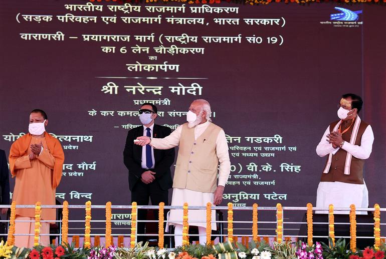 The Prime Minister, Shri Narendra Modi inaugurates six-lane widening project of the Varanasi - Prayagraj section of NH-19, in Varanasi on November 30, 2020. The Chief Minister of Uttar Pradesh, Yogi Adityanath and the Deputy Chief Minister, Uttar Pradesh, Shri Keshav Prasad Maurya are also seen.
