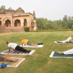 People perform Yoga, on the occasion of the 7th International Day of Yoga 2021, at Lodhi Garden, in New Delhi on June 21, 2021.