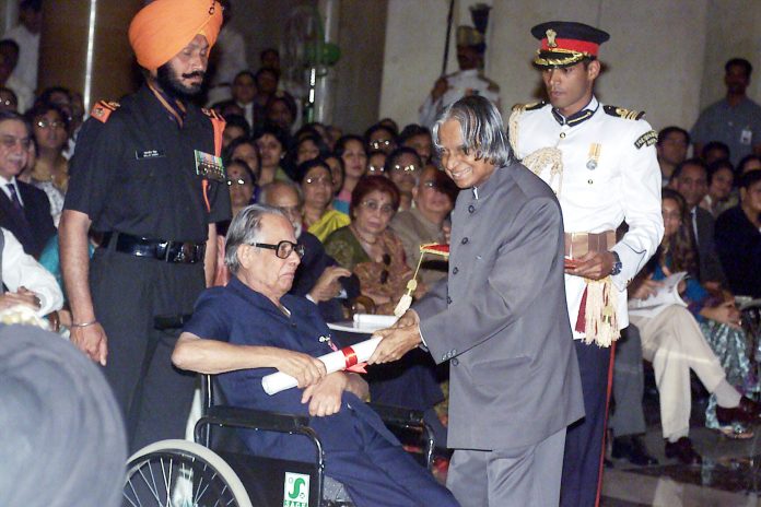 The well-known political cartoonist for the ‘Times of India’ Shri R.K. Laxman receives the Padma Vibhushan award from the President Dr. A.P.J. Abdul Kalam in New Delhi on March 28, 2005 by Wikipedia