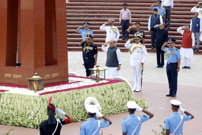 The Union Minister for Defence, Shri Rajnath Singh paying homage to the fallen heroes at National War Memorial, on the occasion of Kargil Vijay Diwas, in New Delhi on July 26, 2022. The Chief of the Army Staff, General Manoj Pande, the Chief of the Air Staff, Air Chief Marshal V.R. Chaudhari and the Chief of Naval Staff, Admiral R. Hari Kumar are also seen.