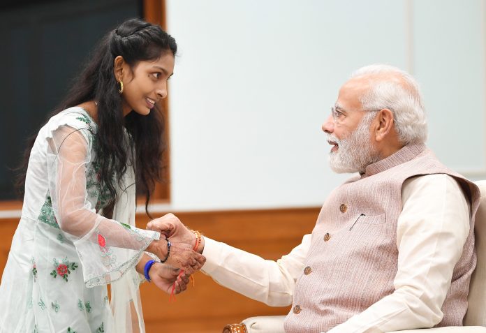 PM celebrates Raksha Bandhan with youngsters at his residence, in New Delhi on August 11, 2022.