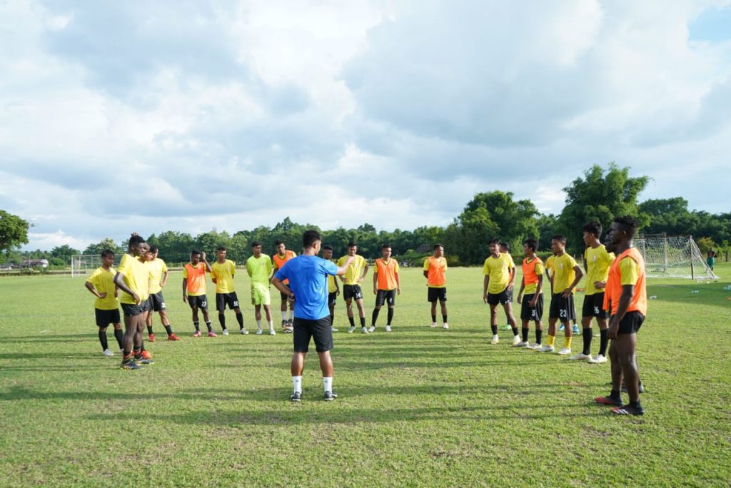 Bodoland FC coach Daimalu Basumatary (back to camera), making a point to his team in training ahead of their 132nd IndianOil Durand Cup game against the Indian Army team in Kokrajhar.