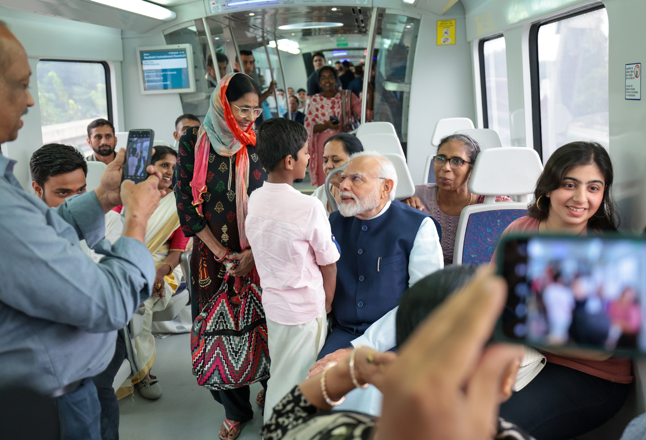 PM interacting with passengers during undertakes metro ride ahead of inauguration the extension of Delhi Airport Metro Express line from Dwarka Sector 21 to a new metro station Yashobhoomi Dwarka Sector 25, in New Delhi on September 17, 2023.