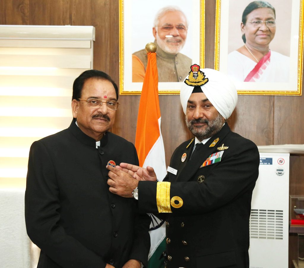 The Secretary, Kendriya Sainik Board Commodore HP Singh pinning a badge on the Minister of State for Defence and Tourism, Shri Ajay Bhatt on the occasion of Armed Forces Flag Day, in New Delhi on December 07, 2023.
