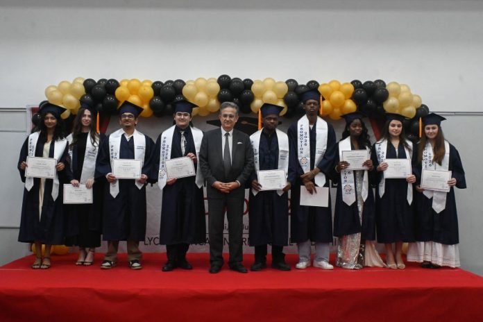 Group photo of the nine graduates with the French Ambassador